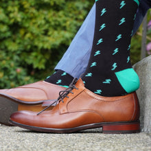 Load image into Gallery viewer, The bright lightning bolt design are inspired by brilliant summer nights at the Cambie and will be a welcome addition to any sock drawer. Black with turquoise highlights make for a memorable combination not soon forgotten. Add finish to any outfit, formal or casual because that’s how you roll.
