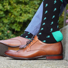 Load image into Gallery viewer, The bright lightning bolt design are inspired by brilliant summer nights at the Cambie and will be a welcome addition to any sock drawer. Black with turquoise highlights make for a memorable combination not soon forgotten. Add finish to any outfit, formal or casual because that’s how you roll.